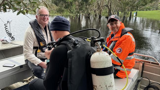 From left: Hedley Thomas, diver Ashley McDonald and Chris D'Arcy from Search Dogs Sydney. Picture: Sean Callinan