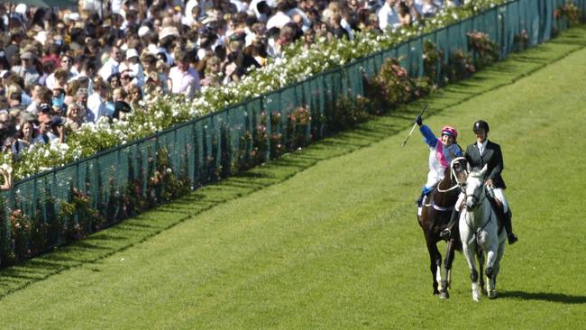 Clare Lindop on Exalted Time salutes the crown after winning the Cup in record time.