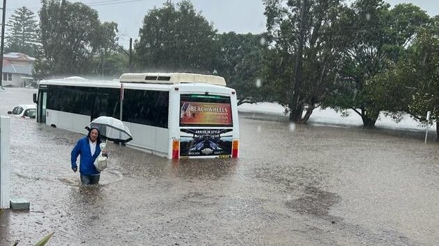 A resident makes their way along flooded Pittwater Rd at North Manly during the flood event on March 8. Northern Beaches Council is writing to the NSW Government to ask that it be included in the recently announced NSW flood inquiry. Picture: Marianne Bray