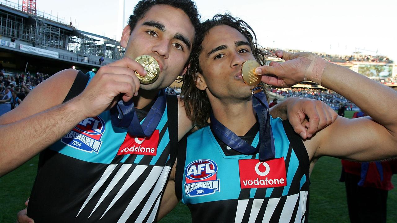 Brothers Shaun and Peter Burgoyne celebrate Port Adelaide’s 2004 premiership.