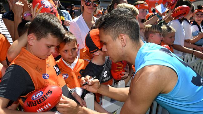 Hill signs autographs for supporters following a training session. Picture: AAP Image/Dan Himbrechts