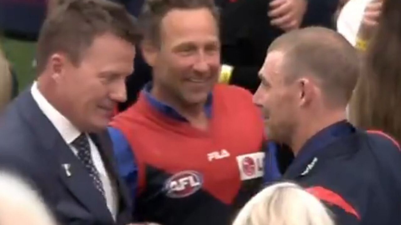 Mr Burbank with commentator James Brayshaw and Melbourne coach Simon Goodwin. Picture: Channel 7