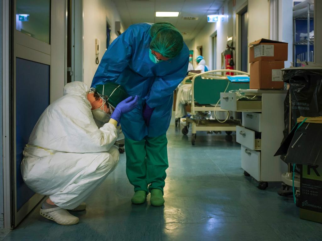 A nurse comforts a colleague at Cremona Hospital near Milan in Italy. Picture: AFP
