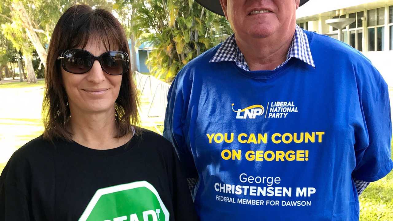 Evelyn Vassallo and Paul Fordyce handing out how to vote cards at Bucasia State School polling station. Picture: Angela Seng