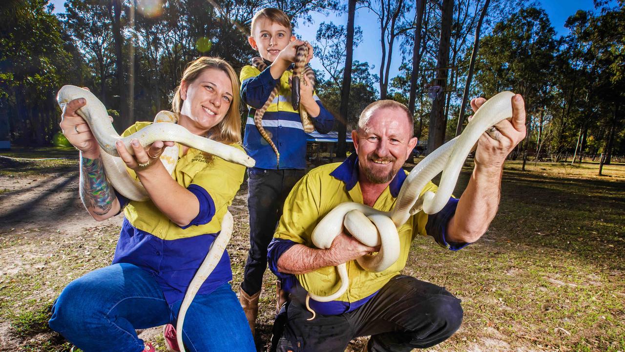 Tony and Brooke Harrison, pictured with their son, were reportedly removing snakes in Logan. Picture: Nigel Hallett