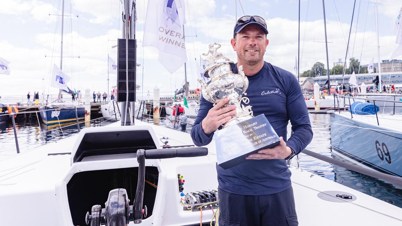 Tasmanian crewman, Troy Grafton on board Celestial with the Tattersalls Cup after winning the overall winner of the Sydney to Hobart. Picture: Linda Higginson