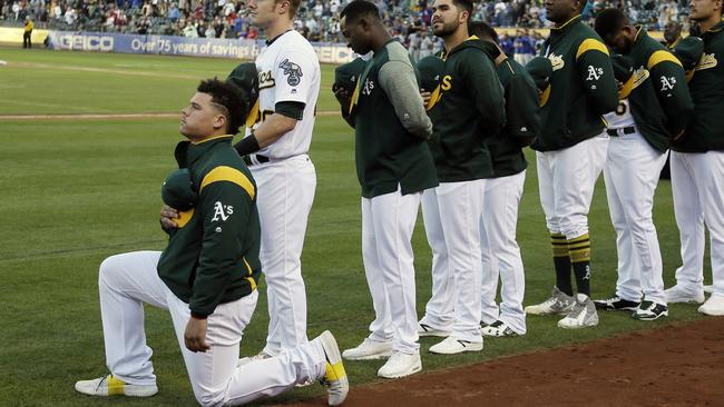 Oakland Athletics catcher Bruce Maxwell kneels during the National Anthem.