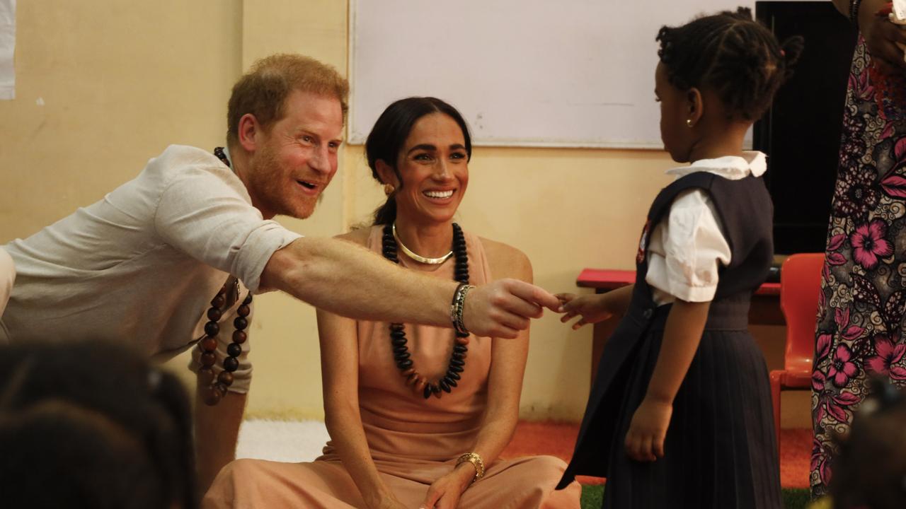 Prince Harry shakes hands with a student at Wuse Lightway Academy. Picture: Getty Images Europe.