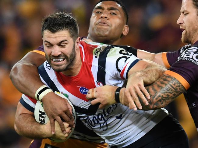 James Tedesco of the Roosters is tackled during the Round 11 NRL match between the Brisbane Broncos and the Sydney Roosters at Suncorp Stadium in Brisbane, Friday, May 18, 2018. (AAP Image/Dan Peled) NO ARCHIVING, EDITORIAL USE ONLY