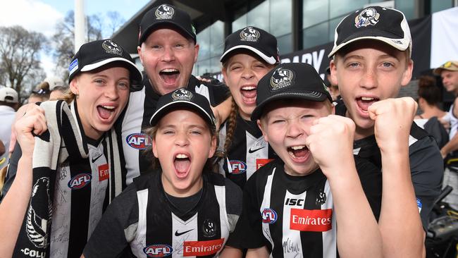 MELBOURNE, AUSTRALIA - NewsWire Photos, OCTOBER 1, 2023. AIA Vitality Centre Oval - Collingwood Family Day where Collingwood players are presented to fans after winning the AFL Grand Final yesterday. (L-R) Daisy Robinson, Glen Cochrane (back), Sadie Robinson, Elsie Robinson, Riley Cochrane and Henry Robinson. Picture: NCA NewsWire / Josie Hayden