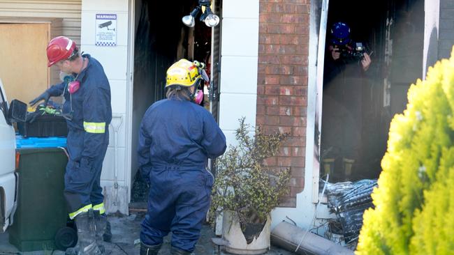 Investigators scour the property for clues. Picture: Dean Martin