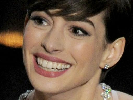 Anne Hathaway accepts the award for best actress in a supporting role for "Les Miserables" during the Oscars at the Dolby Theatre on Sunday Feb. 24, 2013, in Los Angeles. (Photo by Chris Pizzello/Invision/AP)