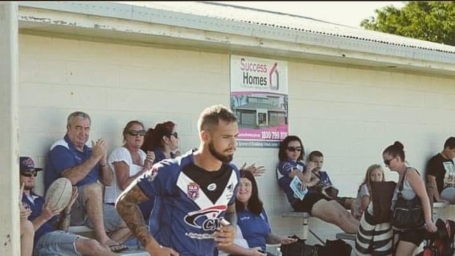 Carlie (fifth from left) looks on as her beloved Roos take to the field.