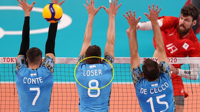 TOKYO, JAPAN - JULY 24: Egor Kliuka #18 of Team ROC hits the ball past the Team Argentina defense during the Men's Preliminary Round - Pool B on day one of the Tokyo 2020 Olympic Games at Ariake Arena on July 24, 2021 in Tokyo, Japan. (Photo by Toru Hanai/Getty Images)