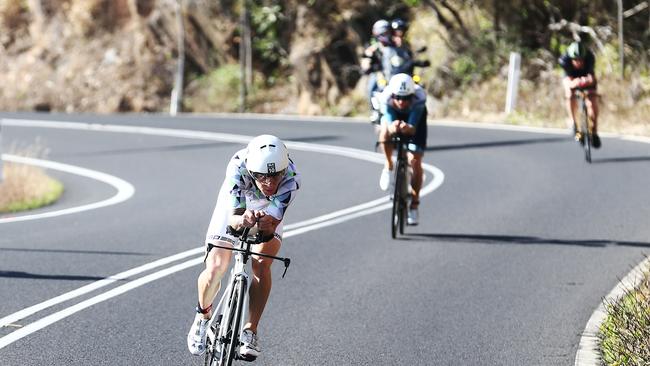 Blake Kappler leads a pack of competitors on the cycle leg of the Ironman Cairns race at Palm Cove beach. PICTURE: BRENDAN RADKE