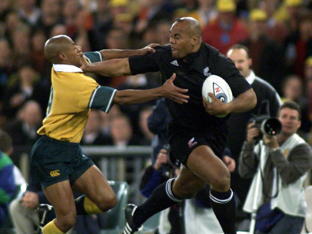 Jonah Lomu is tackled by Wallaby George Gregan at Stadium Australia in 2000.