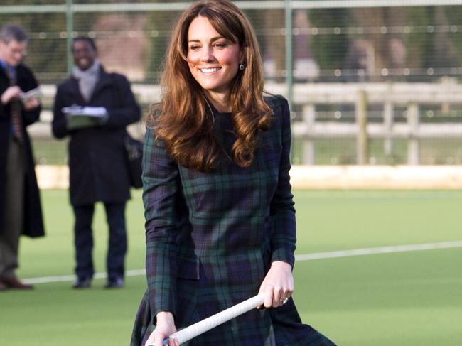 (FILES) - A picture dated November 30, 2012 shows Britain's Catherine, Duchess of Cambridge, playing hockey with students during her visit to St Andrew's School, where she attended school between 1986 and 1995, in Pangbourne, Berkshire, Central England. Prince William's wife Catherine is expecting a baby, though she is in hospital suffering severe morning sickness, St James's Palace announced on December 3, 2012. AFP PHOTO/POOL/ARTHUR EDWARDS