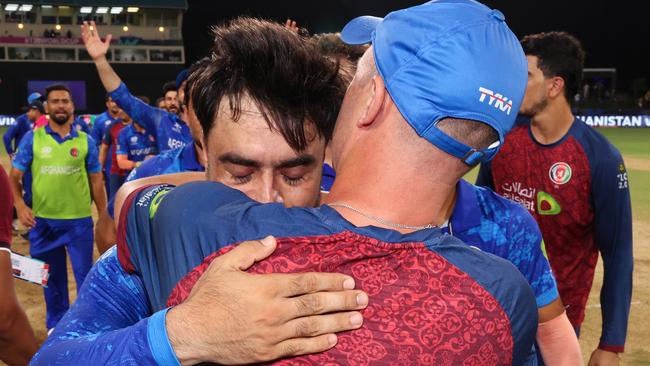 ST VINCENT, SAINT VINCENT AND THE GRENADINES - JUNE 24: Rashid Khan of Afghanistan embraces Jonathan Trott, Head Coach of Afghanistan after the team's victory and to advance to the Semi Finals in the ICC Men's T20 Cricket World Cup West Indies & USA 2024 Super Eight match between Afghanistan and Bangladesh at Arnos Vale Ground on June 24, 2024 in St Vincent, Saint Vincent and The Grenadines. (Photo by Darrian Traynor-ICC/ICC via Getty Images)