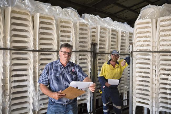 GC Event Hire hire manager / director Gary Love (left) and operations supervisor Mike O'Brien, stand with chairs that in normal circumstances would be hired out, welcome federal government stimulus that will help the business survive after the COVID-19 coronavirus pandemic, Tuesday, March 31, 2020. Picture: Kevin Farmer