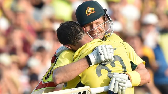 Australia batsman Glenn Maxwell (L) gets a hug from Shane Watson (R) after scoring a century during the 2015 Cricket World Cup Pool A match between Australia and Sri Lanka at the Sydney Cricket Ground on March 8, 2015. AFP PHOTO/Peter PARKS --IMAGE RESTRICTED TO EDITORIAL USE - STRICTLY NO COMMERCIAL USE--