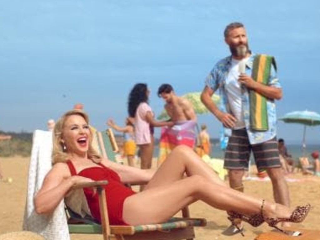 Kylie Minogue and Adam Hills in the ad. Picture: News360