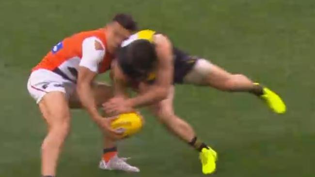 Richmond skipper Trent Cotchin collects Giant Dylan Shiel in the preliminary final.