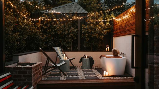 Braithwaite outdoor bath in the garden courtyard under the twinkly fairy lights. For TasWeekend travel story. ONE-TIME USE ONLY for re-use must contact Kirsty Eade. MUST CREDIT Renee Thurston