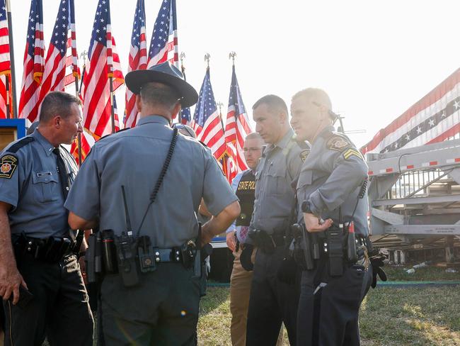 BUTLER, PENNSYLVANIA - JULY 13: Law enforcement agents stand near the stage of a campaign rally for Republican presidential candidate former President Donald Trump on July 13, 2024 in Butler, Pennsylvania. According to Butler County District Attorney Richard Goldinger, the suspected gunman is dead after injuring former President Trump, killing one audience member and injuring at least one other.   Anna Moneymaker/Getty Images/AFP (Photo by Anna Moneymaker / GETTY IMAGES NORTH AMERICA / Getty Images via AFP)