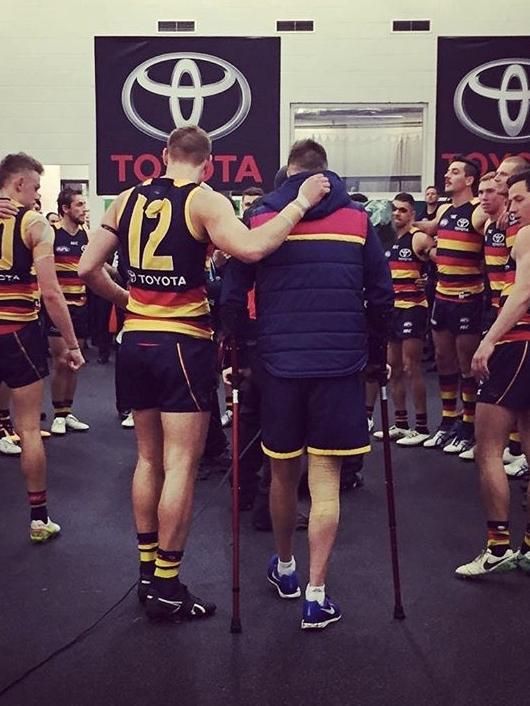 Smith is comforted by Daniel Talia as his teammates belt out the club song in the win against GWS in last year’s semi-final. Picture: Reece Homfray.