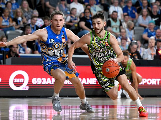 Ben Ayre dribbles clear of Isaac White. Picture: Bradley Kanaris/Getty Images