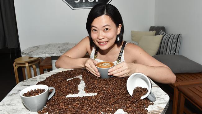 Jules Mou with a flat white from Kopi Stop which has been judged Darwin’s best coffee shop. PICTURE: Katrina Bridgeford.