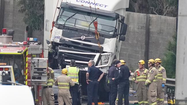 Police and emergency services work at the scene of the crash. Picture: AAP