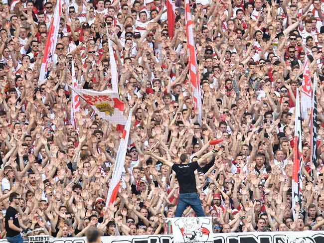 Fans of VfB Stuttgart cheer their team.