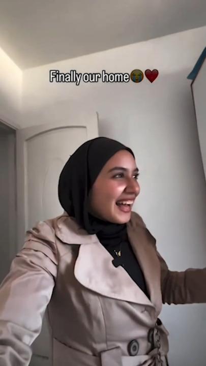 Palestinian woman cries as she finds apartment in Gaza still standing