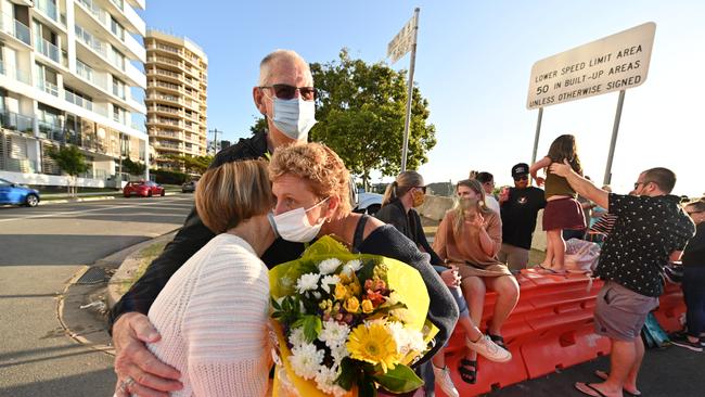 Families separated at the Queensland-NSW border embrace.