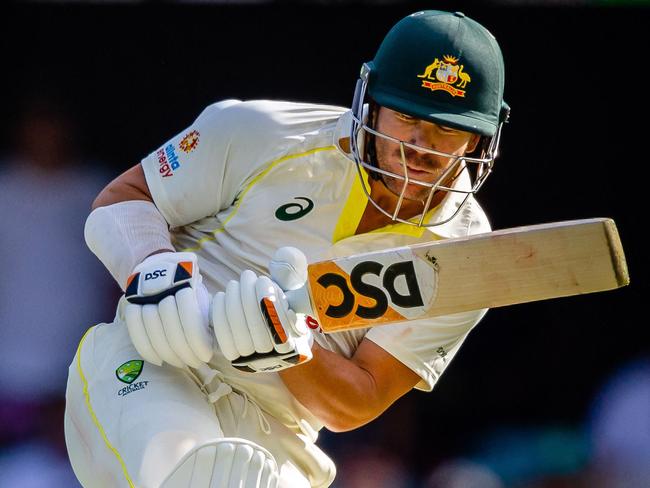 Australia's David Warner ducks under a rising delivery during the second day of the first cricket Test match between Australia and South Africa at the Gabba in Brisbane on December 18, 2022. (Photo by Patrick HAMILTON / AFP) / - IMAGE RESTRICTED TO EDITORIAL USE - STRICTLY NO COMMERCIAL USE-