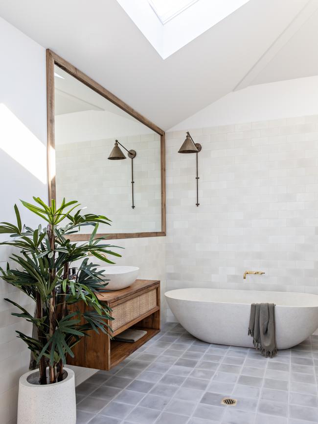 The bathroom features a modern standalone tub.