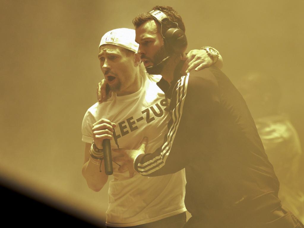 English comedian Simon Brodkin , playing his character Lee Nelson, is escorted by security after interrupting Kanye West as he performs at the 2015 Glastonbury Festival. Picture: AFP