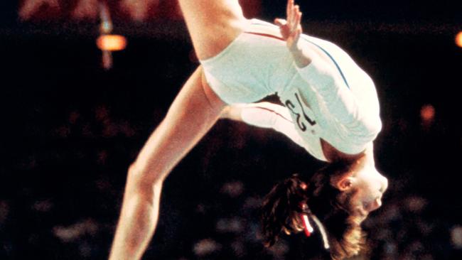 Nadia Comaneci, on the beam at the 1976 Olympics, was abused as a young athlete, it is claimed, by Bela and Martha Karolyi, who allegedly starved, beat and psychologically abused the young star and fellow pupils. Picture: AFP