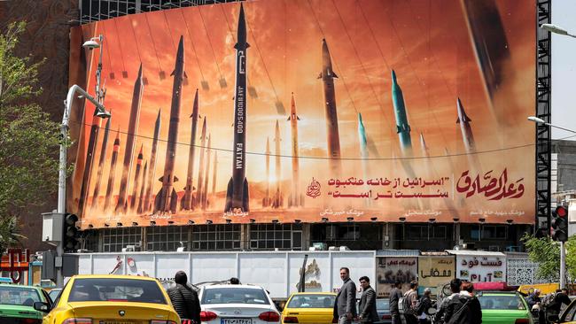 Billboards showing ballistic missiles were raised in central Tehran on Monday. Iran has warned Israel not to retaliate to its attack at the weekend. Picture: Atta Kenare/AFP