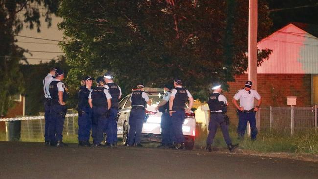 Police establish a crime scene and search for evidence. Picture: Steve Tyson.