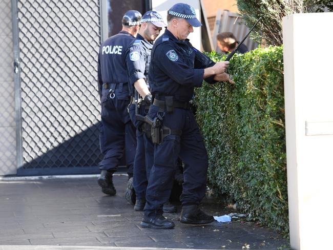 NSW Police officers search the home. Picture: AAP Image/Paul Miller