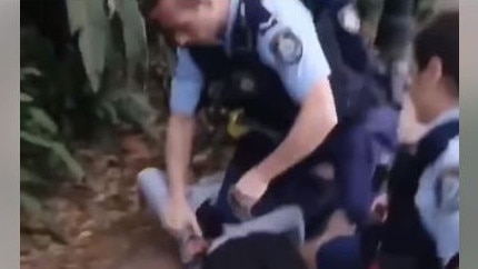 An Aboriginal teen is held on the ground by police in Sydney's Surry Hills. Picture: Facebook