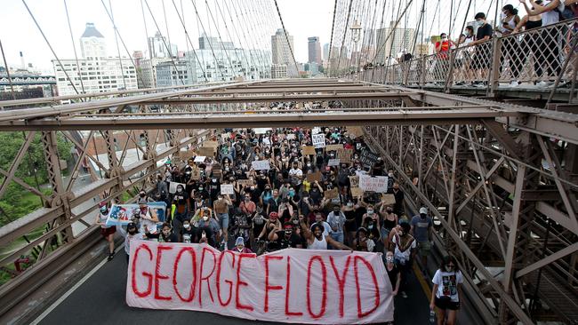 People walk over the Brooklyn Bridge following a memorial service for George Floyd. Picture: Getty Images