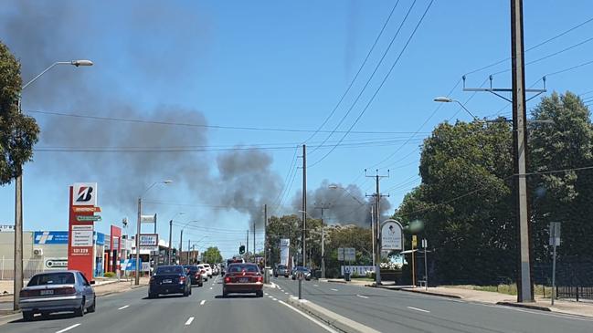 Smoke was billowing across North East Rd as crews worked to contain a house fire at Hillcrest. Picture: Renato Castello