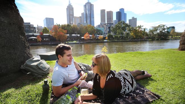 Melbourne experiencing unseasonably warm weather for this time of year. Andrew Wood-Collier and Emma Hall having a picnic on the Yarra. Picture: Alex Coppel.