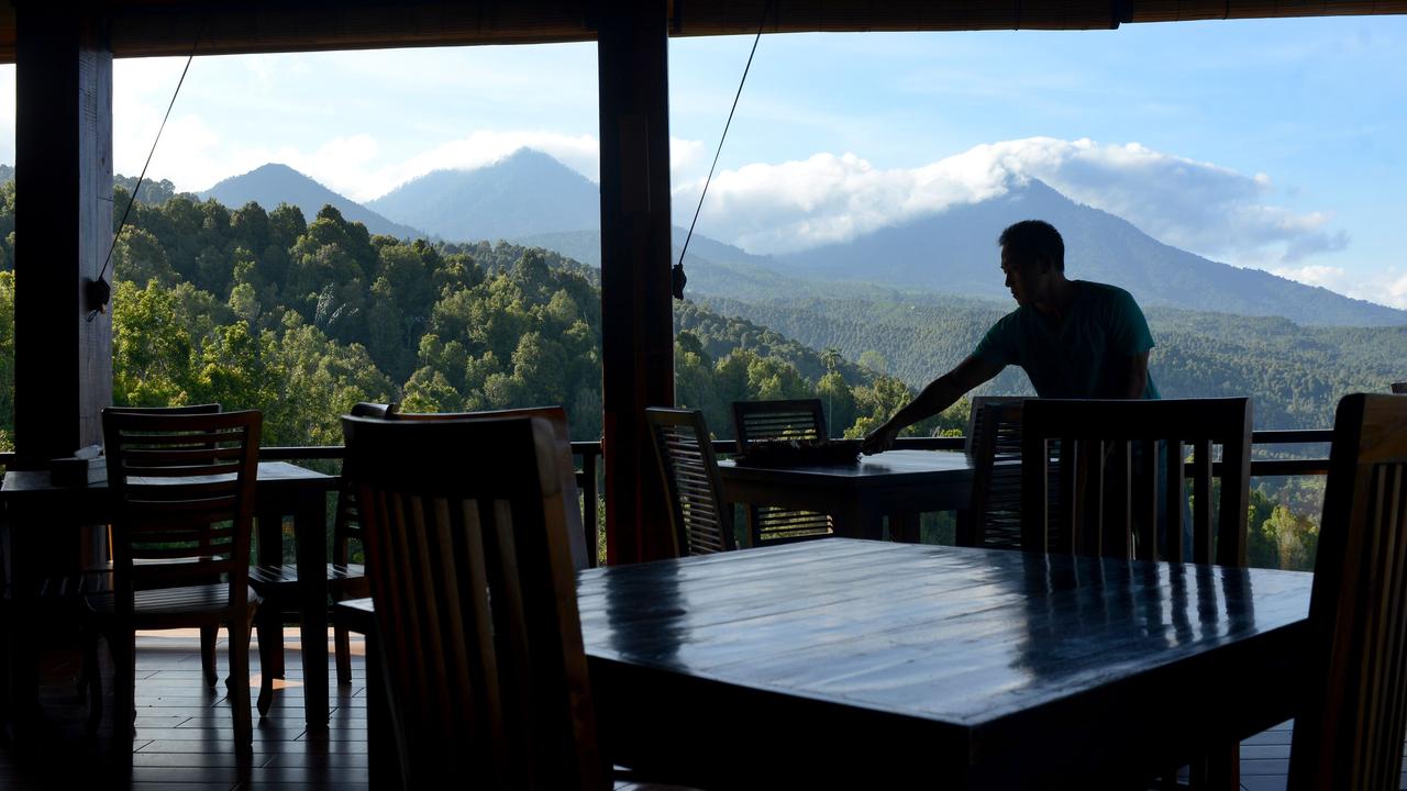 An employee cleans a table inside a villa’s restaurant. Picture: Sonny Tumbelaka/AFP