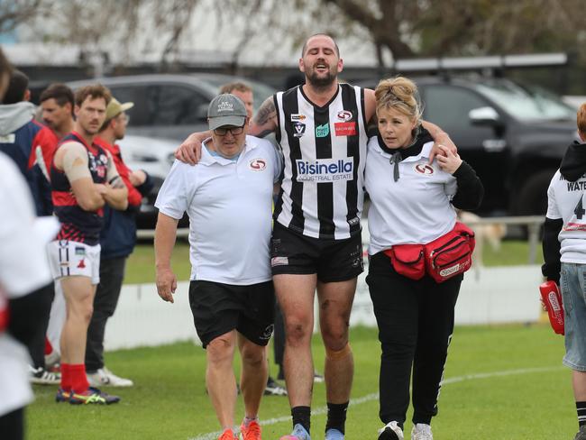North Geelong's Blake Miller was helped from the field. Picture: Alan Barber