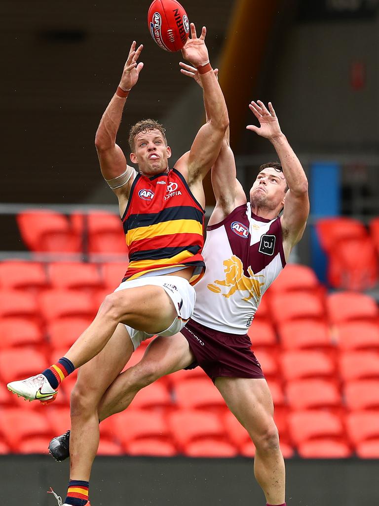 Mitch Hinge and Lachie Neale climb for a mark.