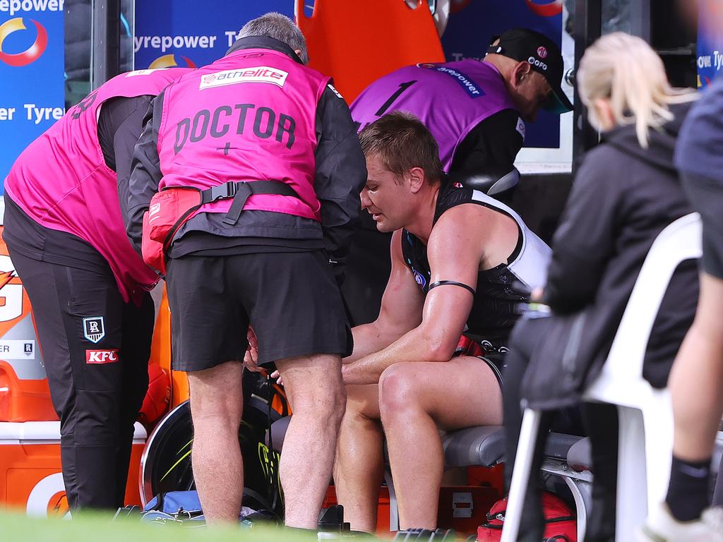 ADELAIDE, AUSTRALIA - MAY 19: Ollie Wines of the Power in the hands of Doctors on the bench during the 2024 AFL Round 10 match between Yartapuulti (Port Adelaide Power) and the Hawthorn Hawks at Adelaide Oval on May 19, 2024 in Adelaide, Australia. (Photo by Sarah Reed/AFL Photos via Getty Images)